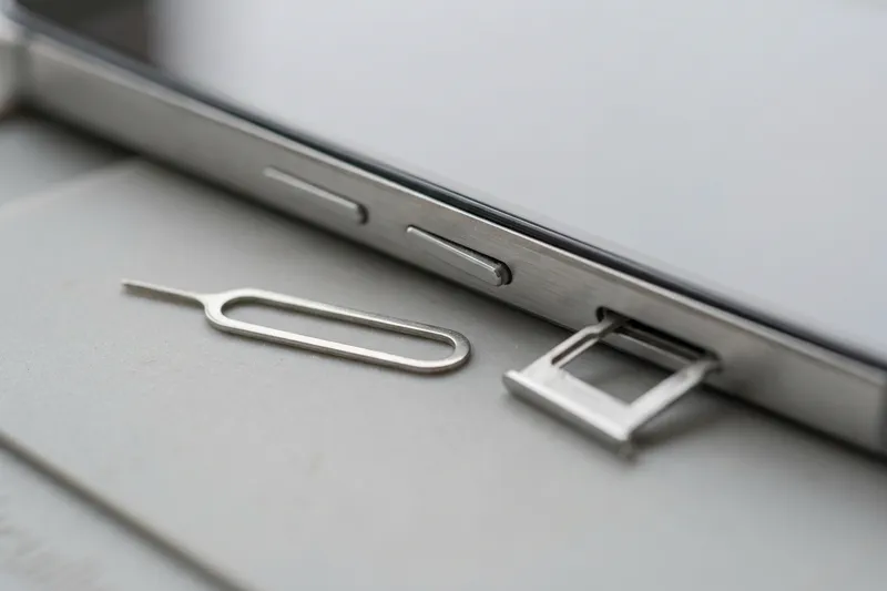 Side of a smartphone with buttons and the SIM tray pulled out